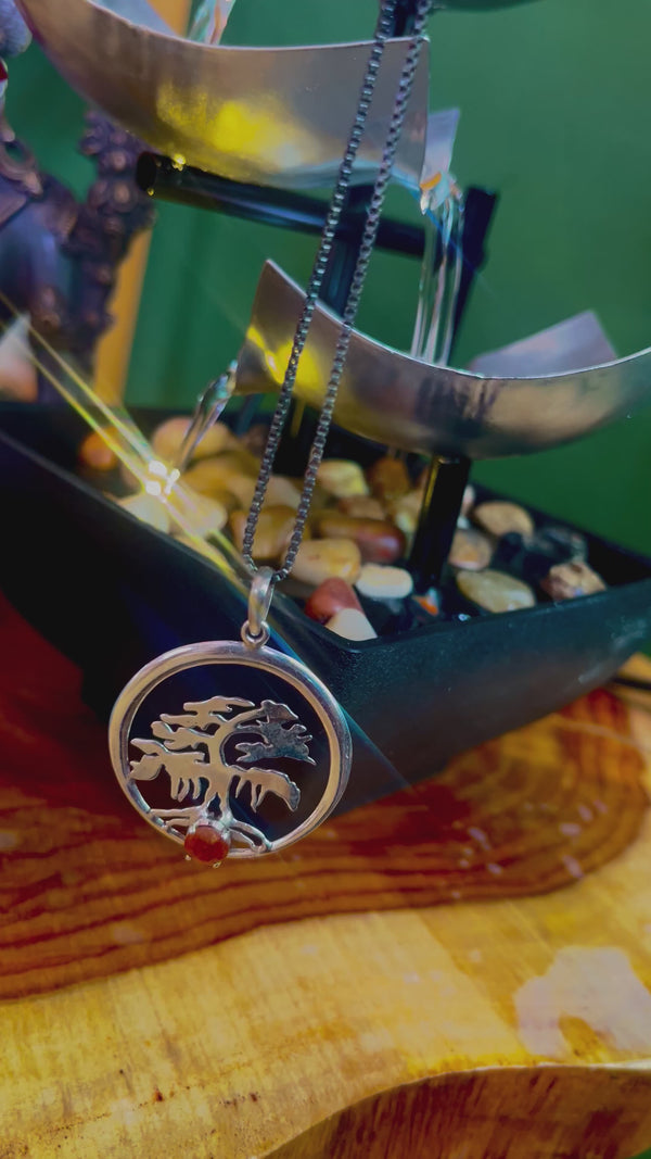 “Radiant Tree of Life Pendant: Handcrafted Silver with Carnelian Center”